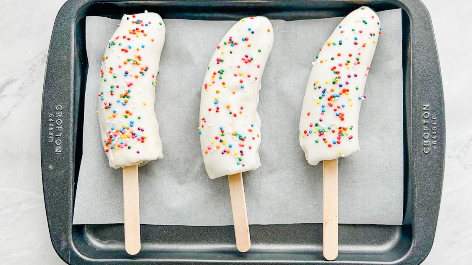 Banana yogurt popsicles with sprinkles.