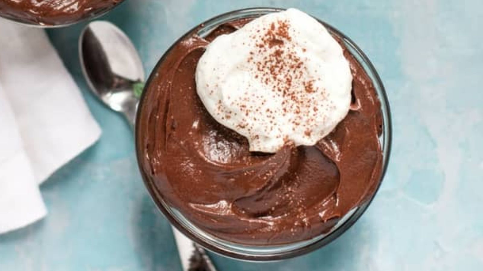 Chocolate pudding with cream on top.