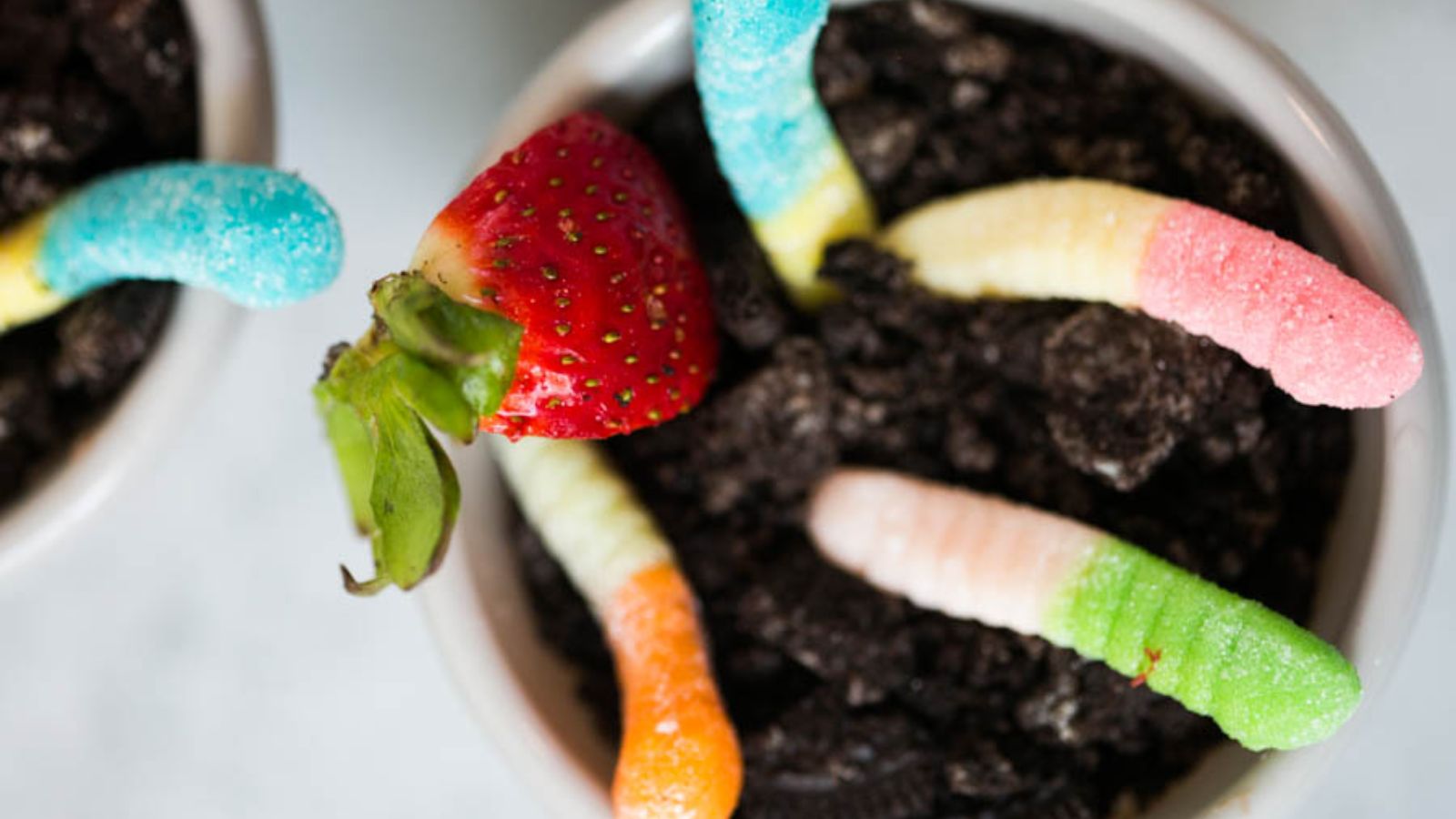 Oreo pudding cups with worms and strawberry.
