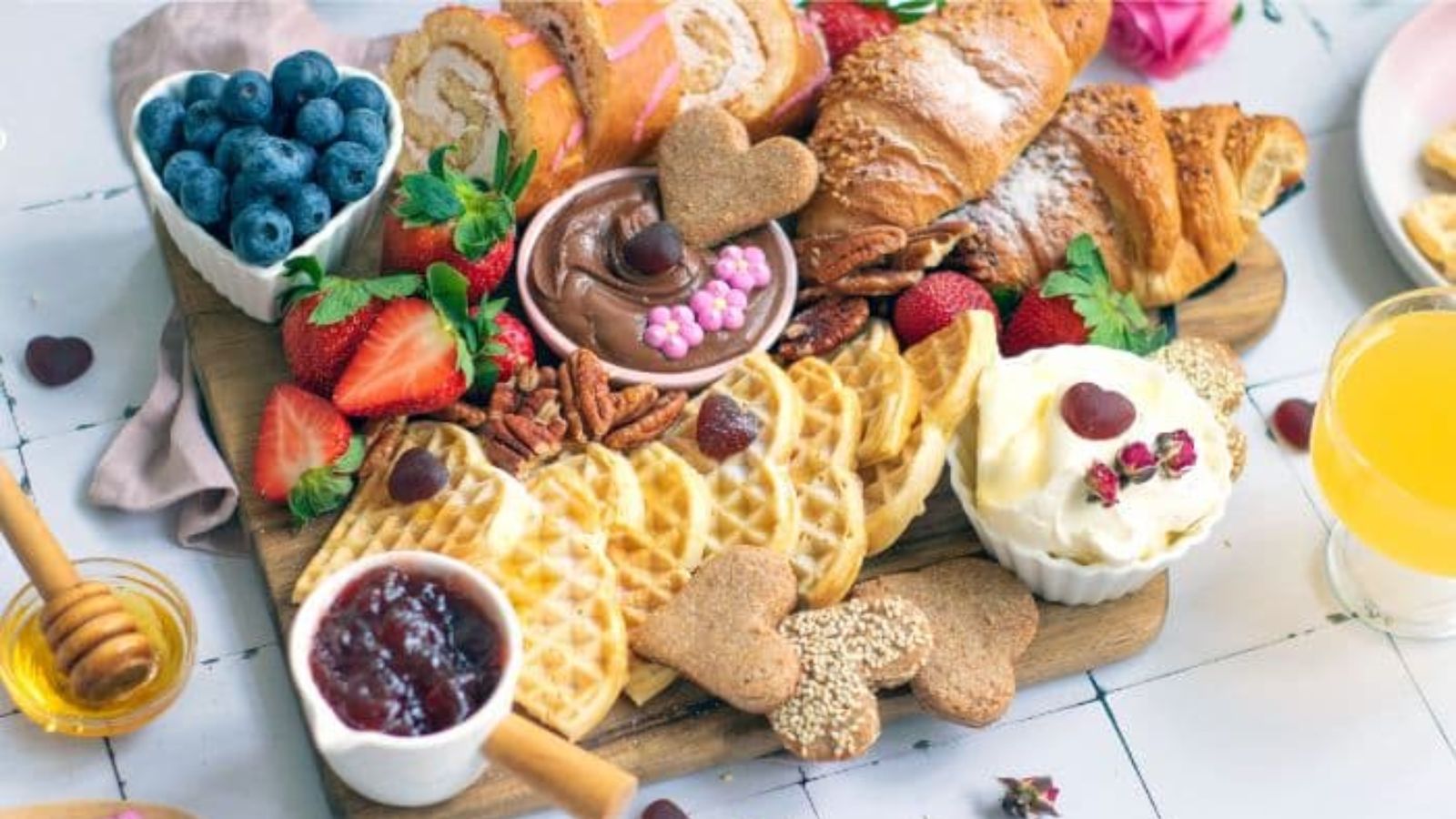 Mixed breads with berries on a wooden board.