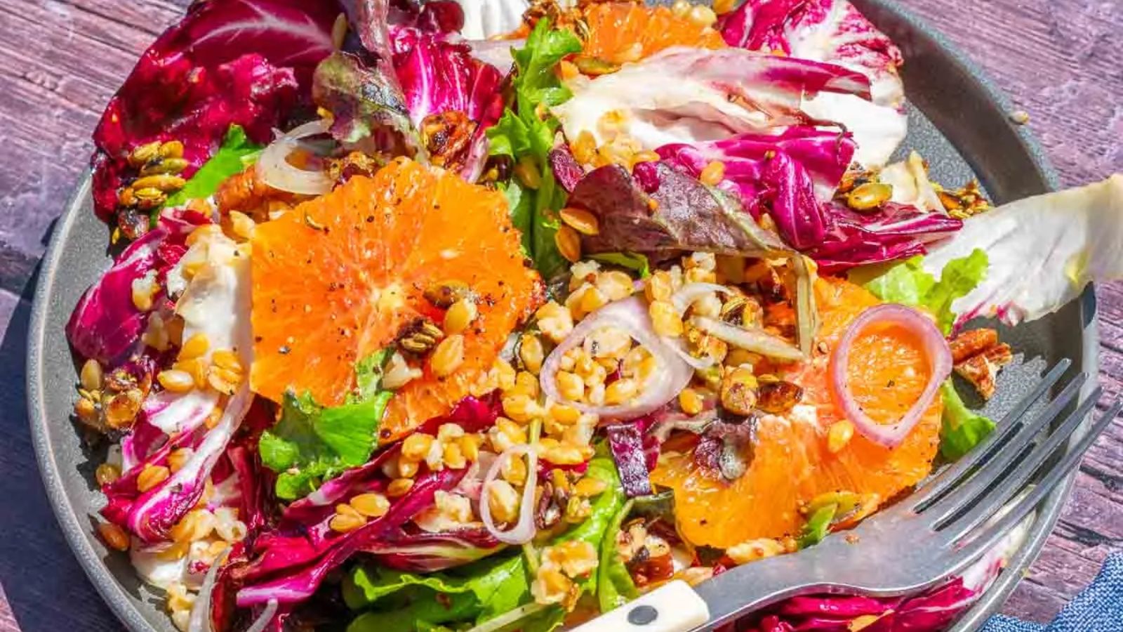 Salad with oranges on a plate.