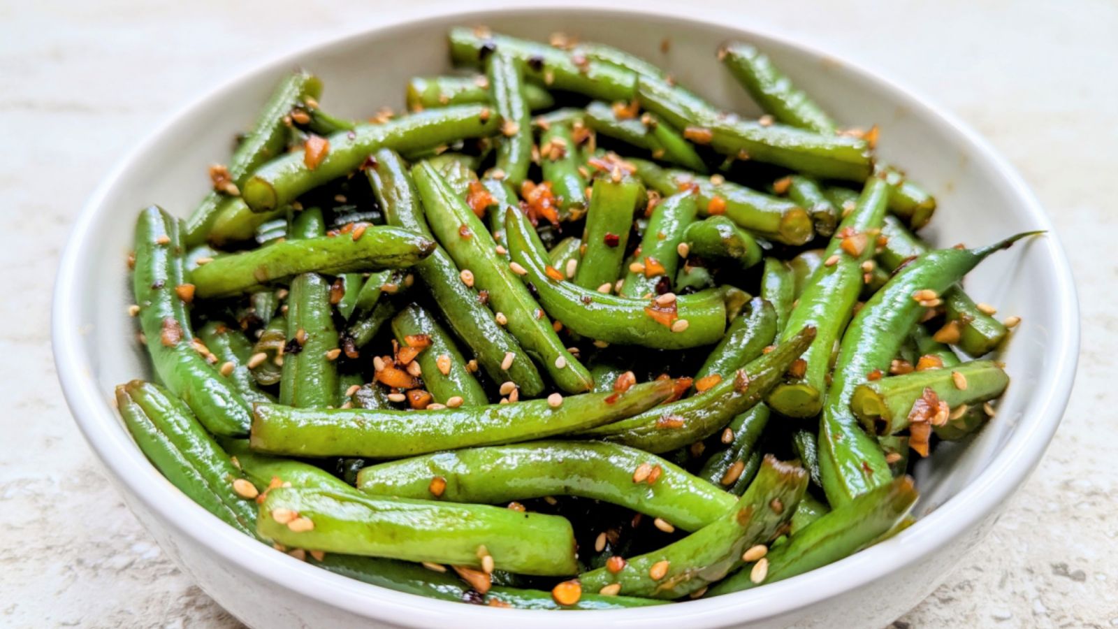 Green beans with sesame seeds in a bowl.