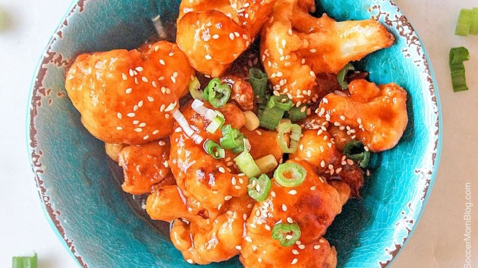 Cauliflower coated with sauce in a bowl.
