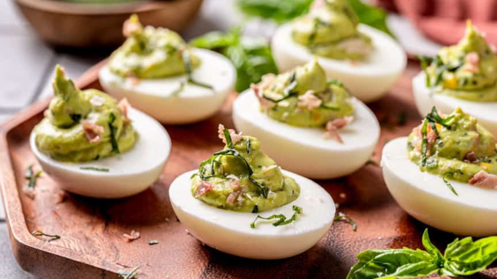 Deviled eggs on a wooden plate.