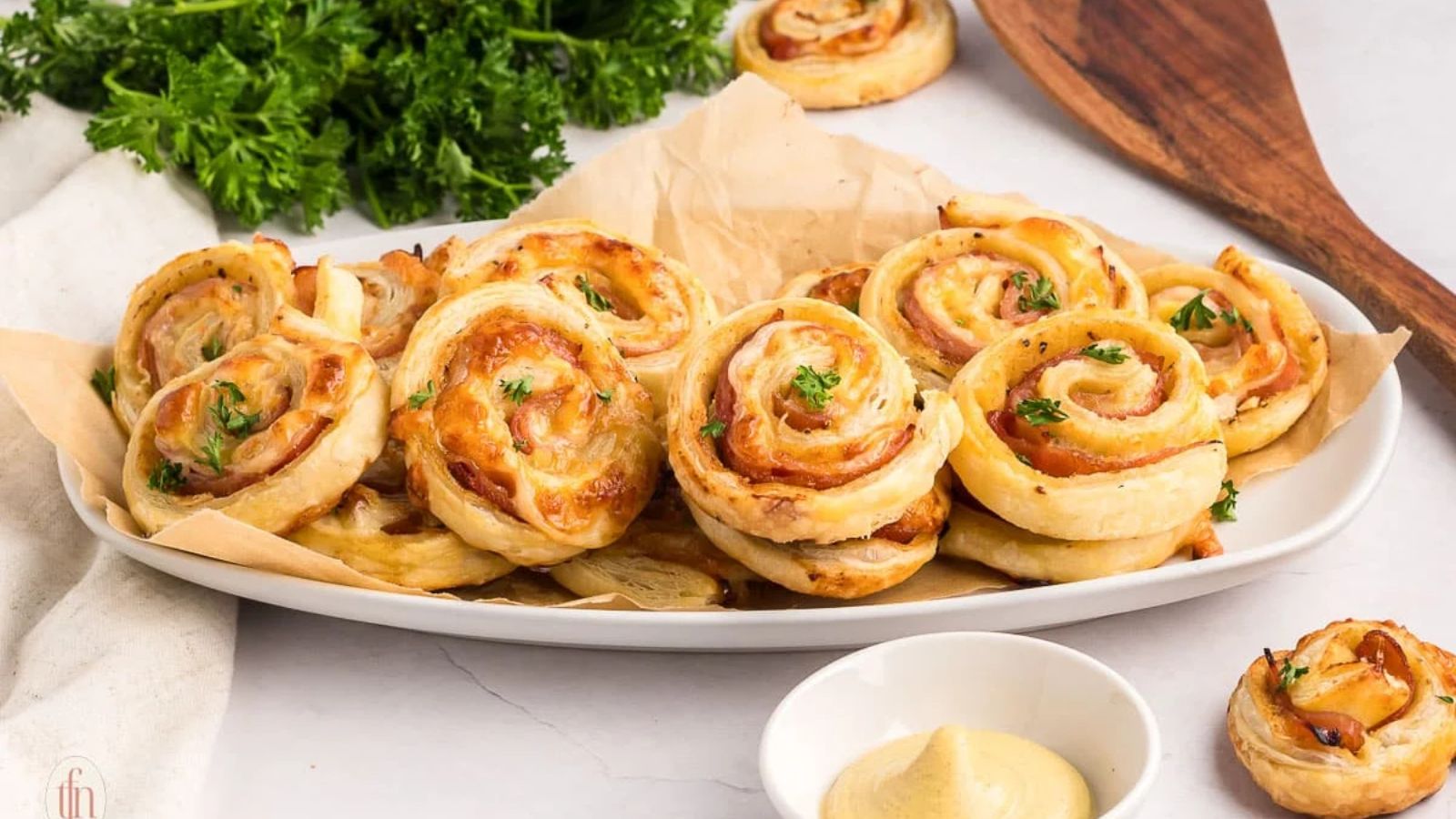 Ham and cheese pinwheels on a plate.