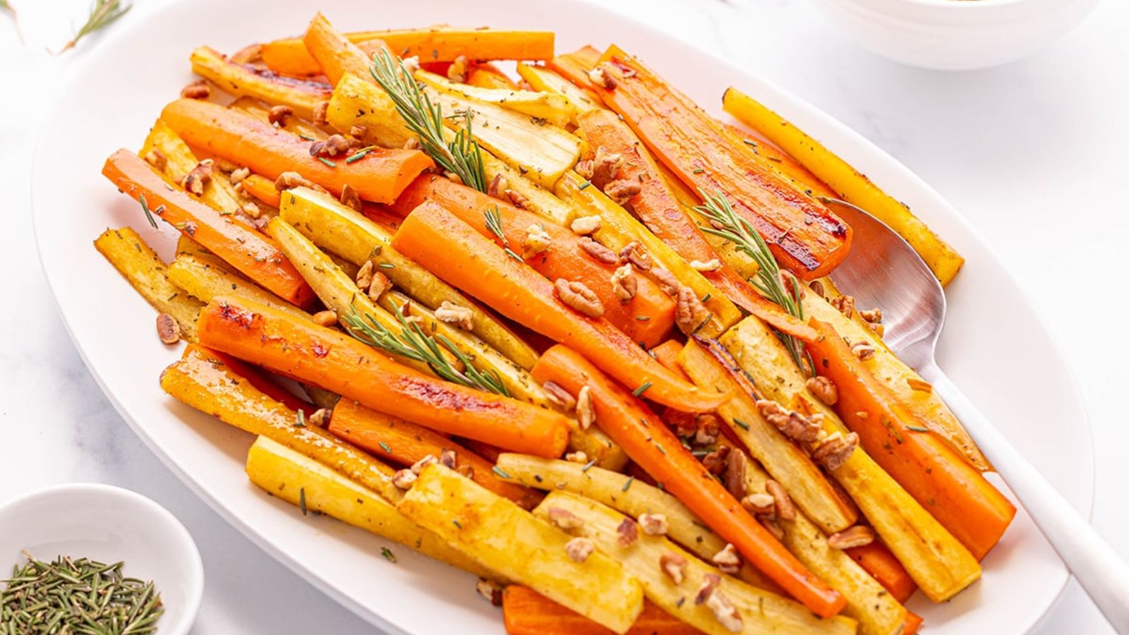 Roasted carrots and parsnips on a plate.