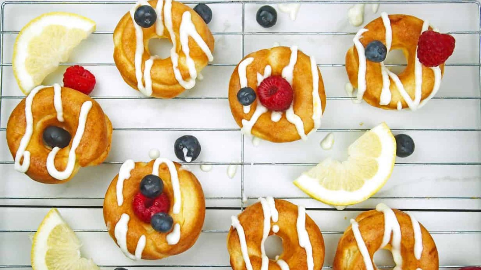 Donuts with sliced lemons and blueberries.