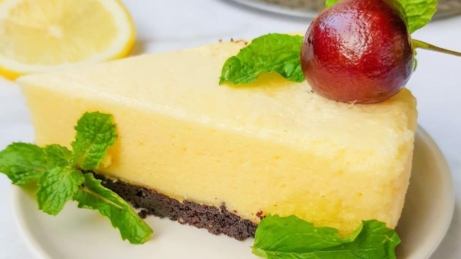 A slice of lemon cake with cherry.