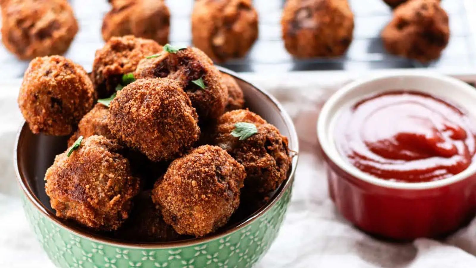 Fried meatballs with dip on the side.
