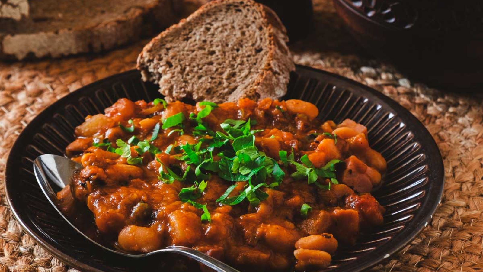 Soup with beans and sliced bread.