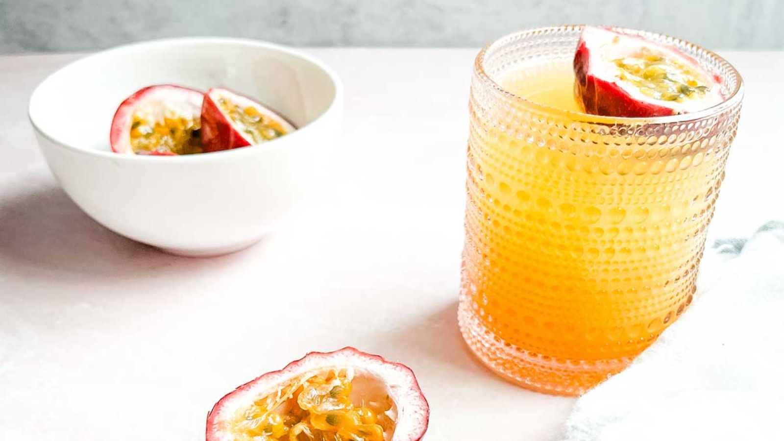 A glass of passionfruit cocktail.