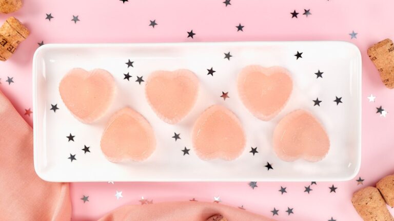 Pink champagne jello shots on a plate.