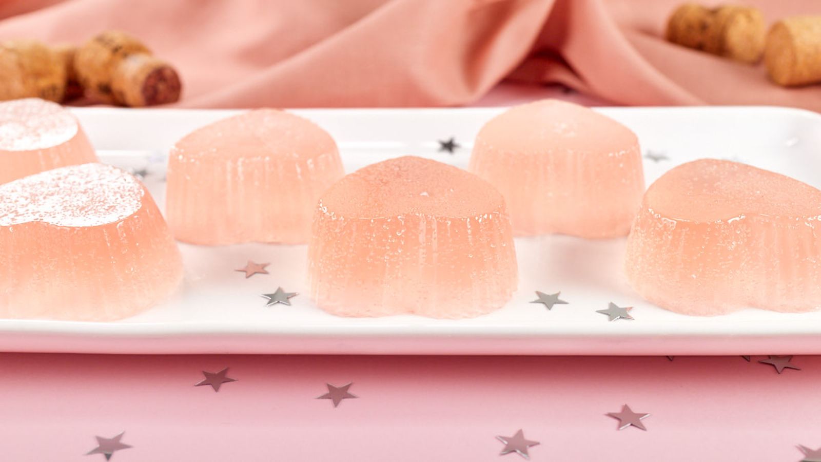Pink champagne jello shots on a plate.