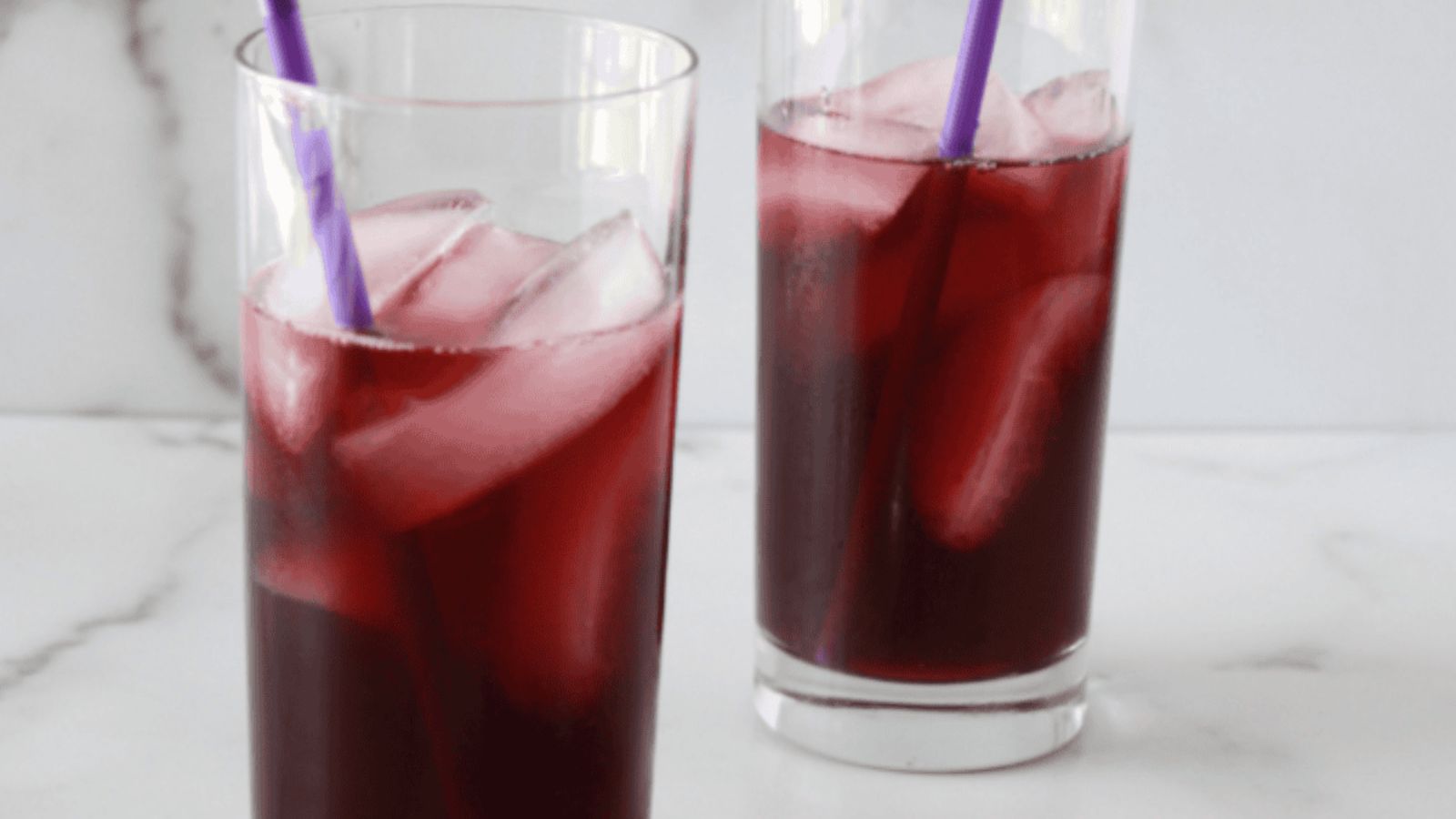 Two glasses of purple cocktails.