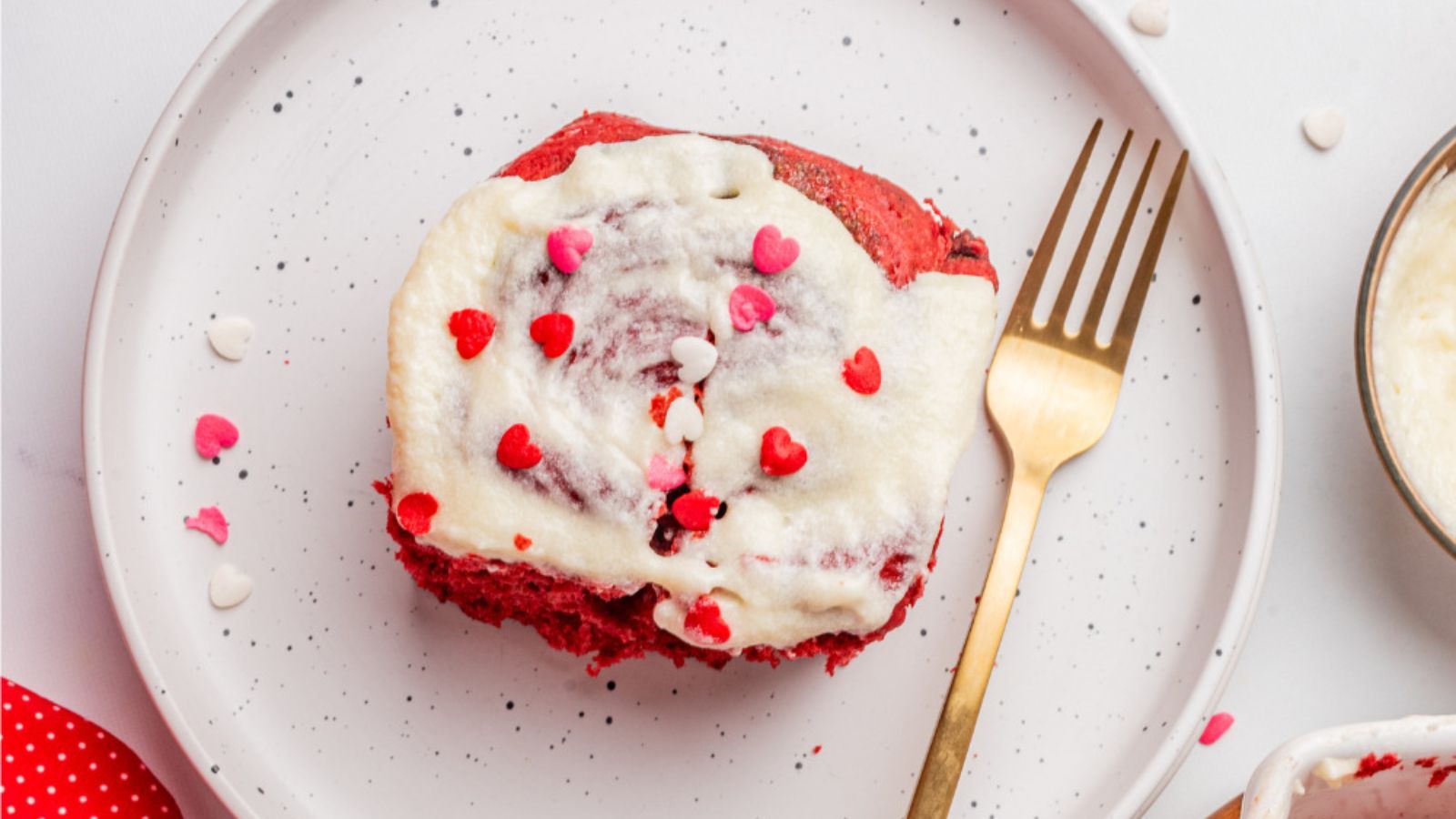 Red velvet cinnamon roll on a plate.