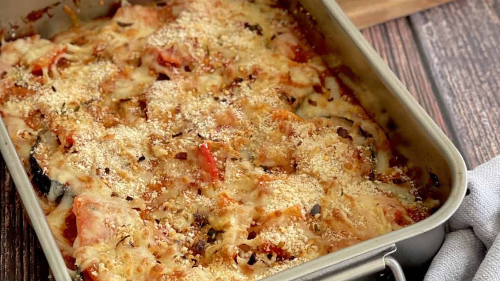 roasted eggplant and red bell pepper on a tray.