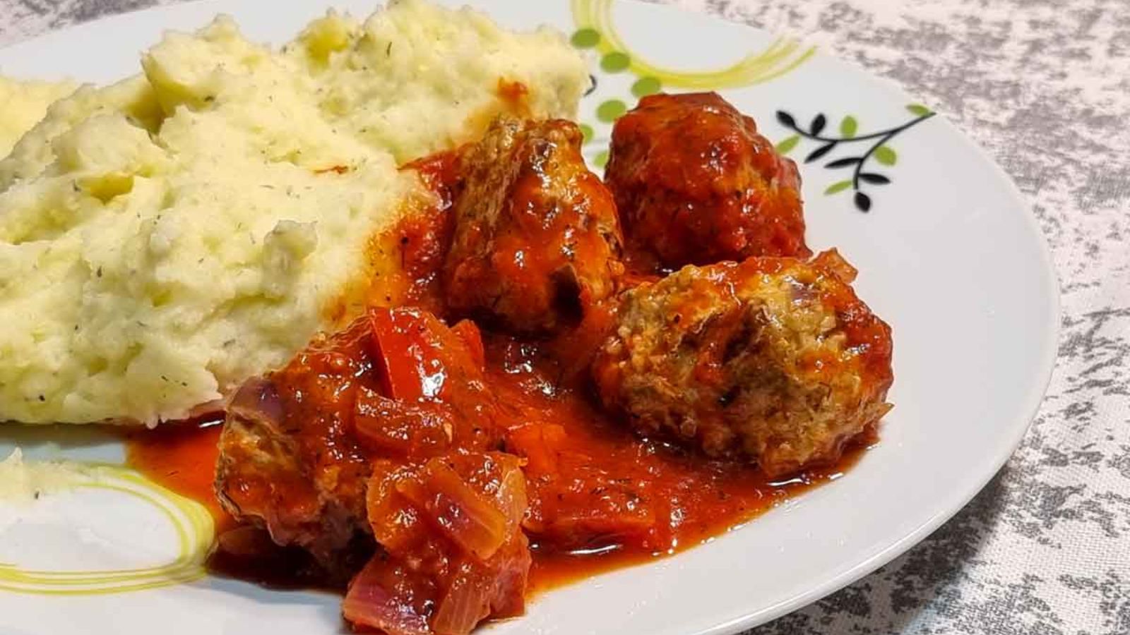 Meatballs and mashed potatoes on a plate.