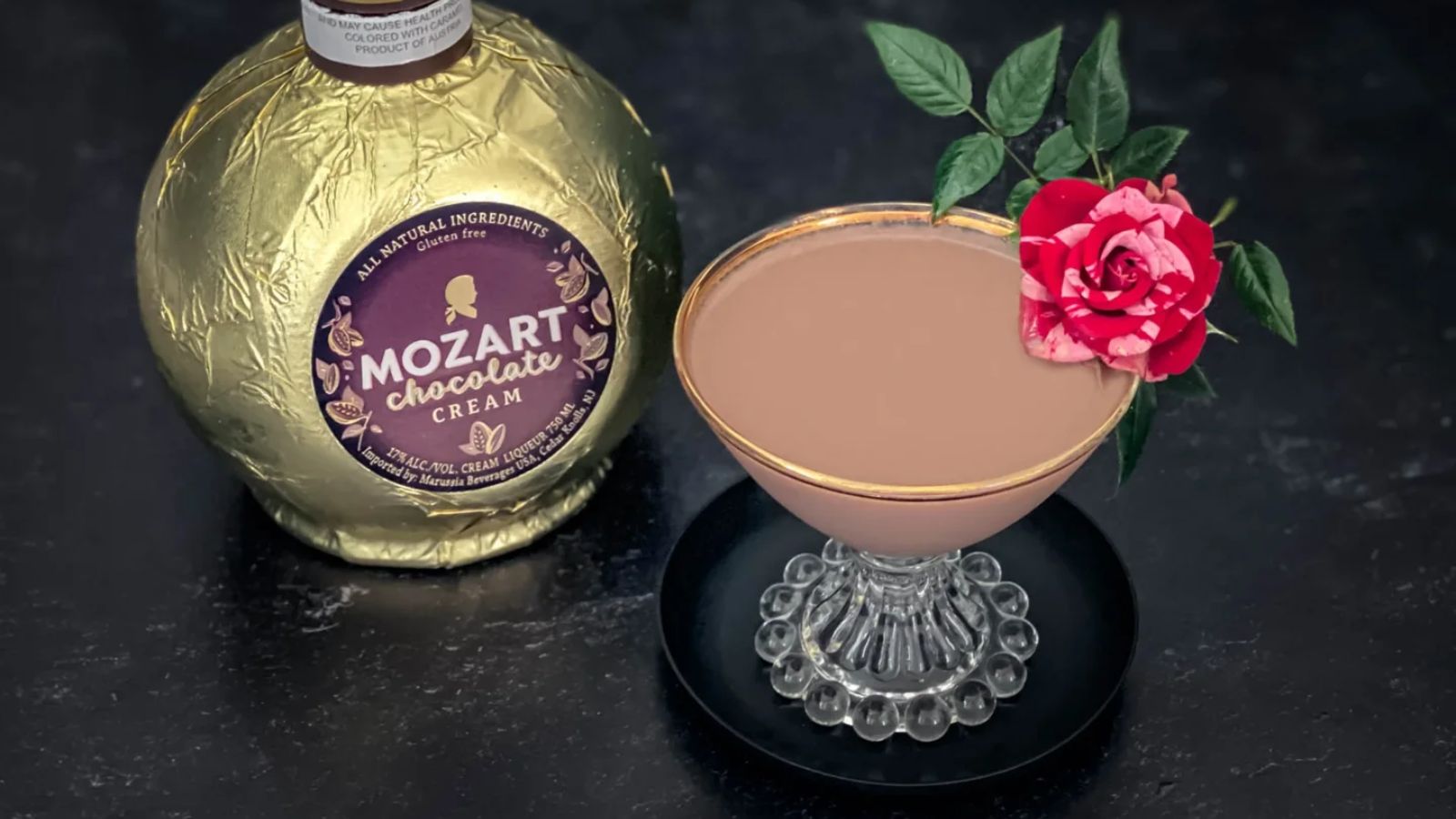 Chocolate martinin= in a glass with a bottle of chocolate cream on the side.