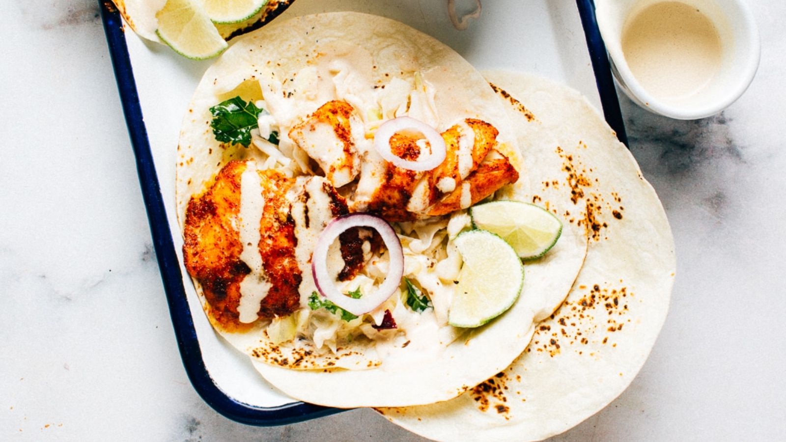 Tacos with fish and sauce.