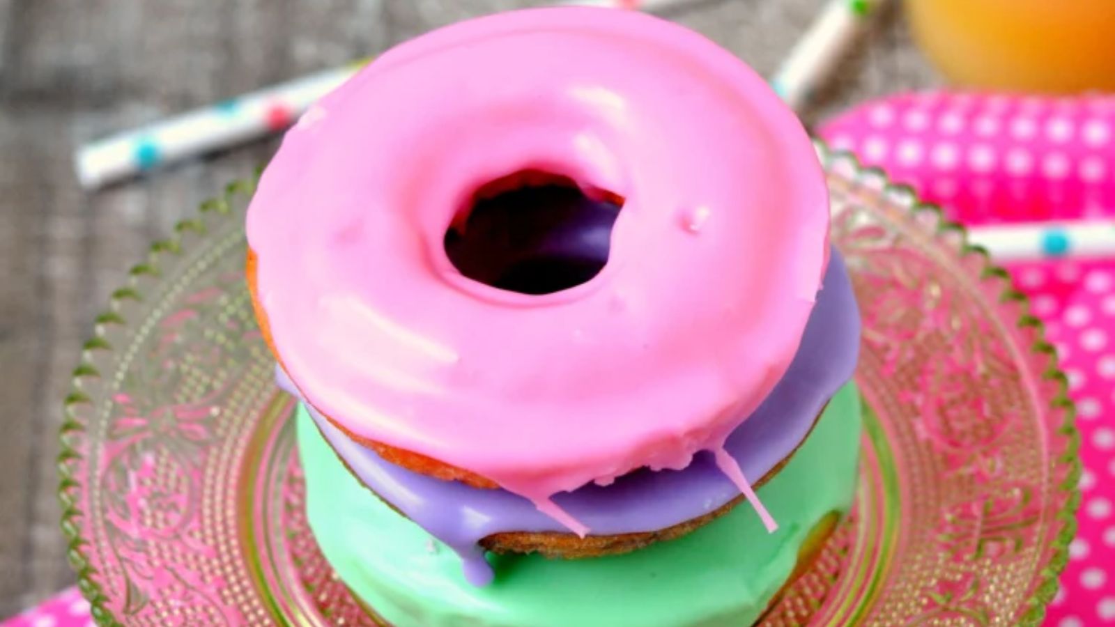 A stack of colorful donuts on a plate.