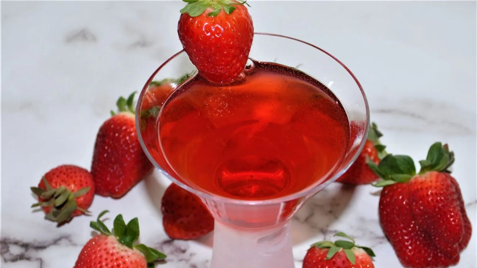 Strawberry martini with fresh strawberries.