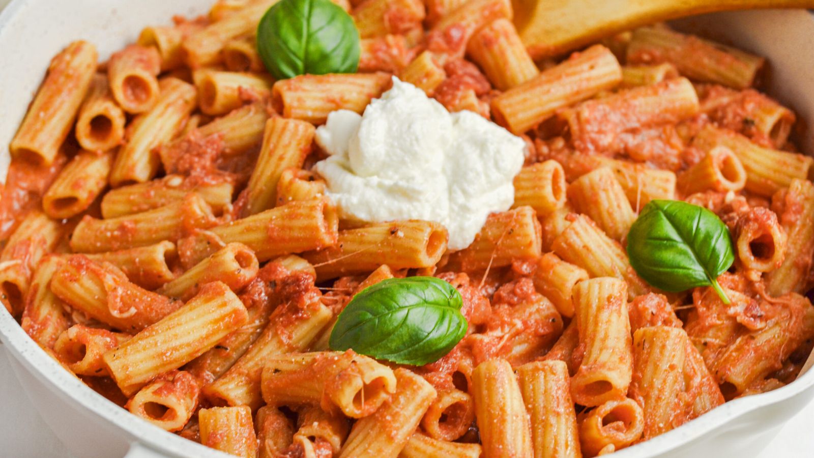 Pasta with cheese on top.