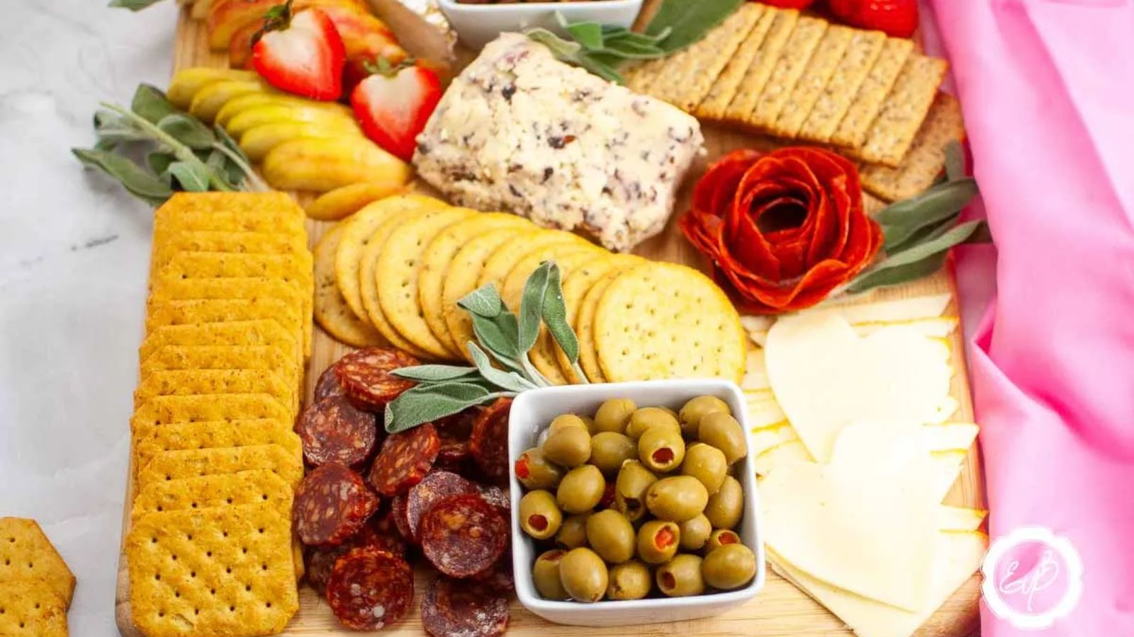 Mixed biscuits, with cheese and olives on a wooden board.