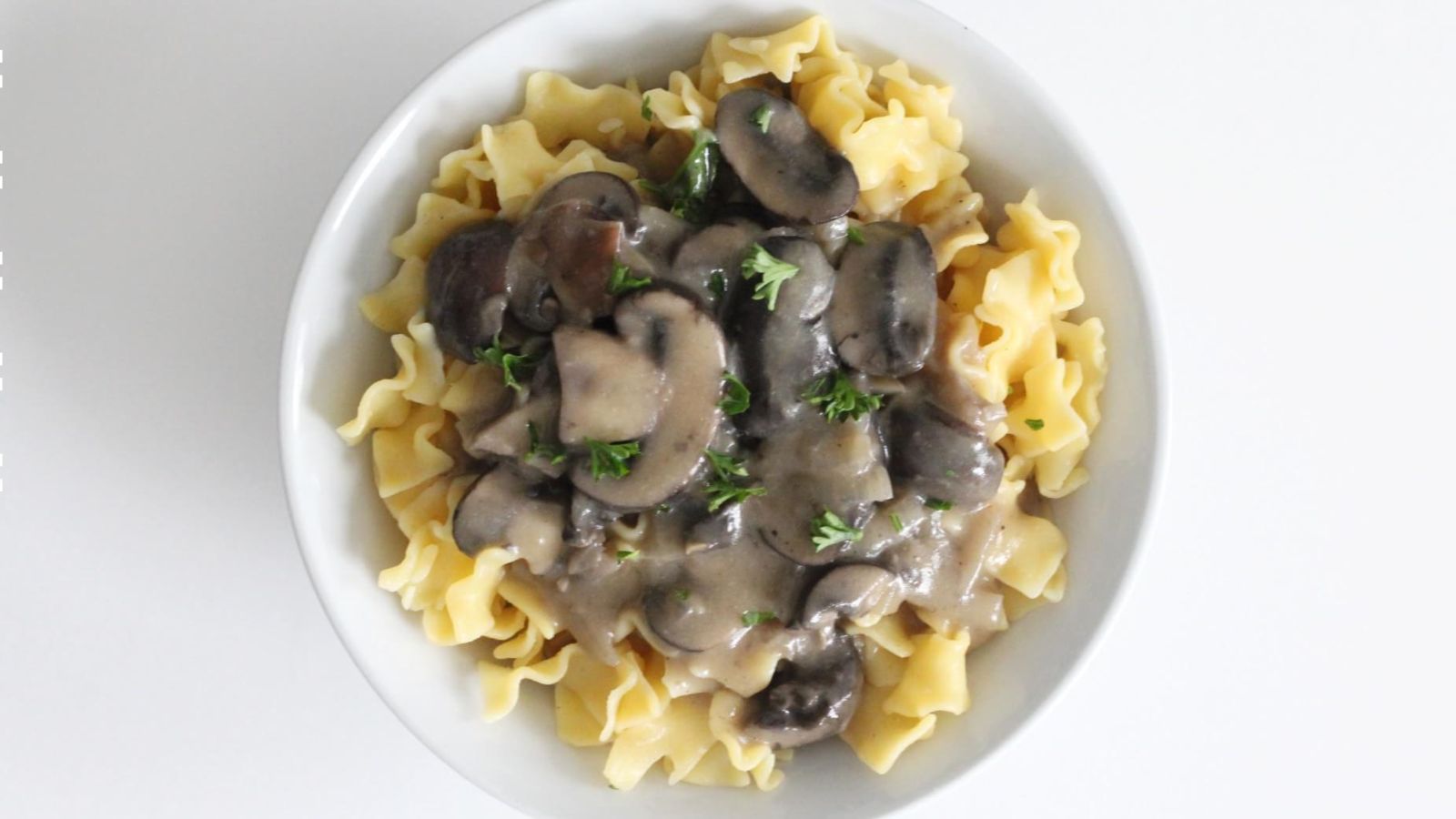 Pasta with mushrooms on top.