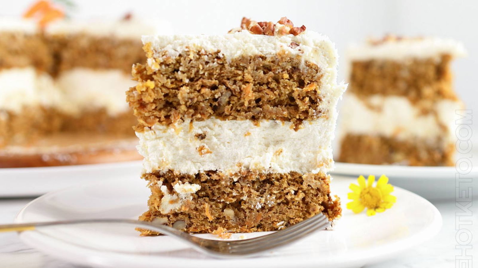 A slice of carrot cake on a plate.