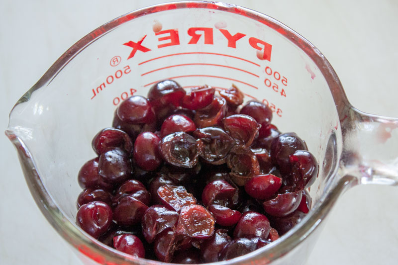 Pitted cherries in a mixing bowl.