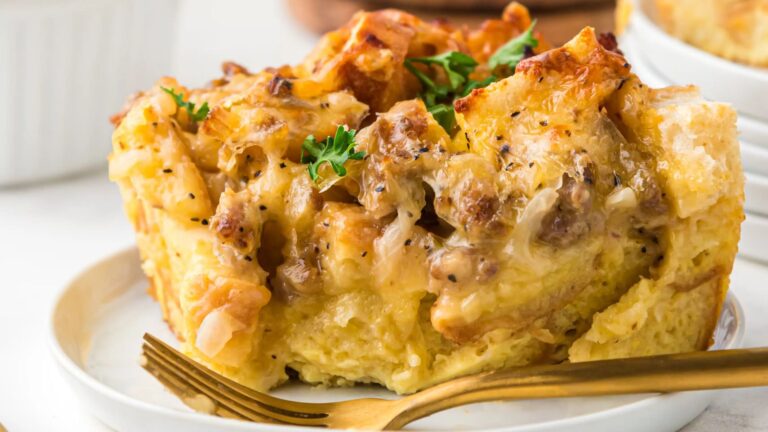Piece of a breakfast casserole on a white plate.