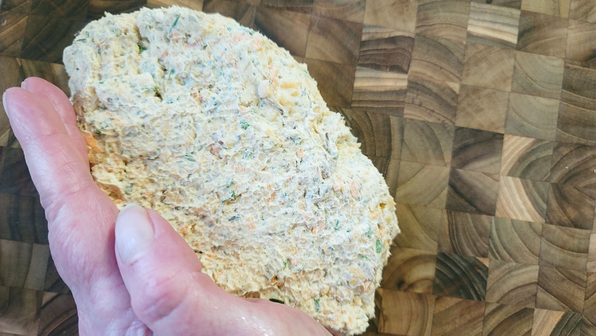 Cheese ball being shaped into a football.