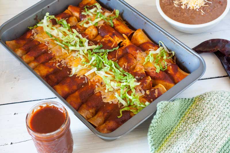 tray of easy chicken enchiladas with refried beans
