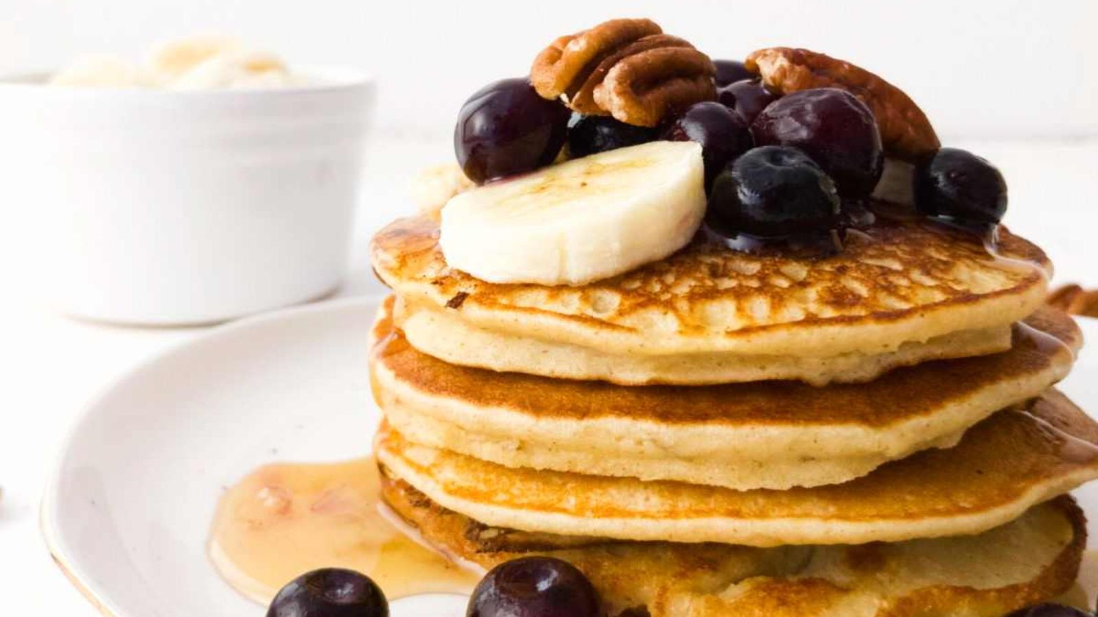 Stack of pancakes with fruits.