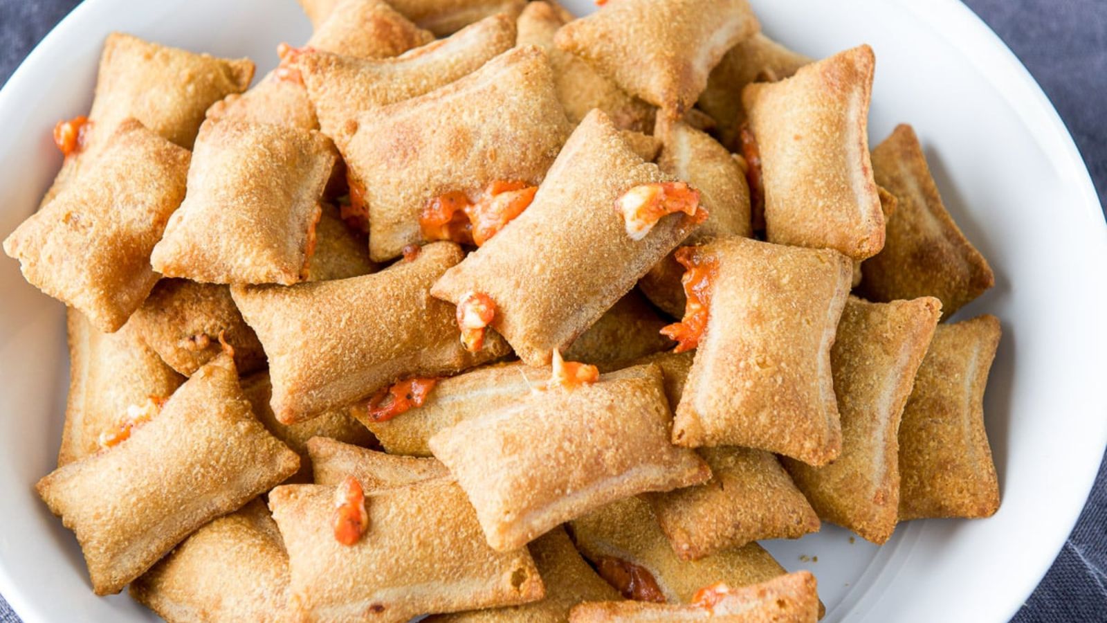 Pizza rolls on a plate.