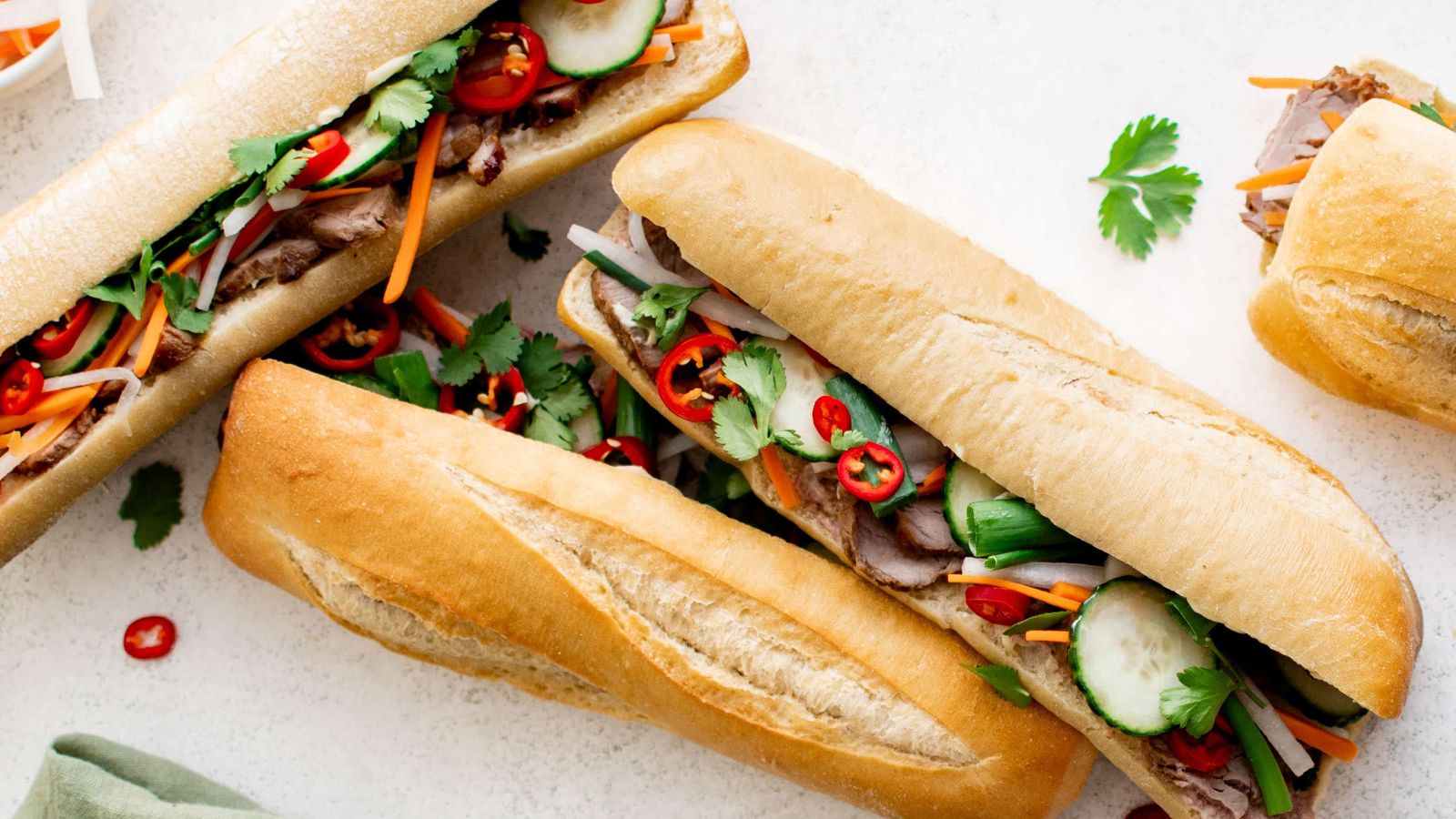 Three sandwiches with peppers.