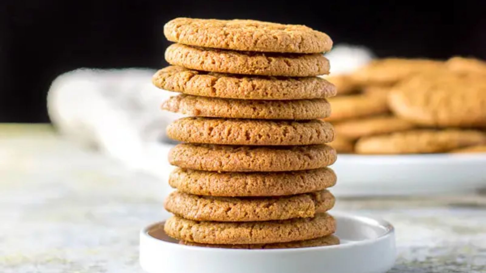 Stack of molasses cookies on a plate.