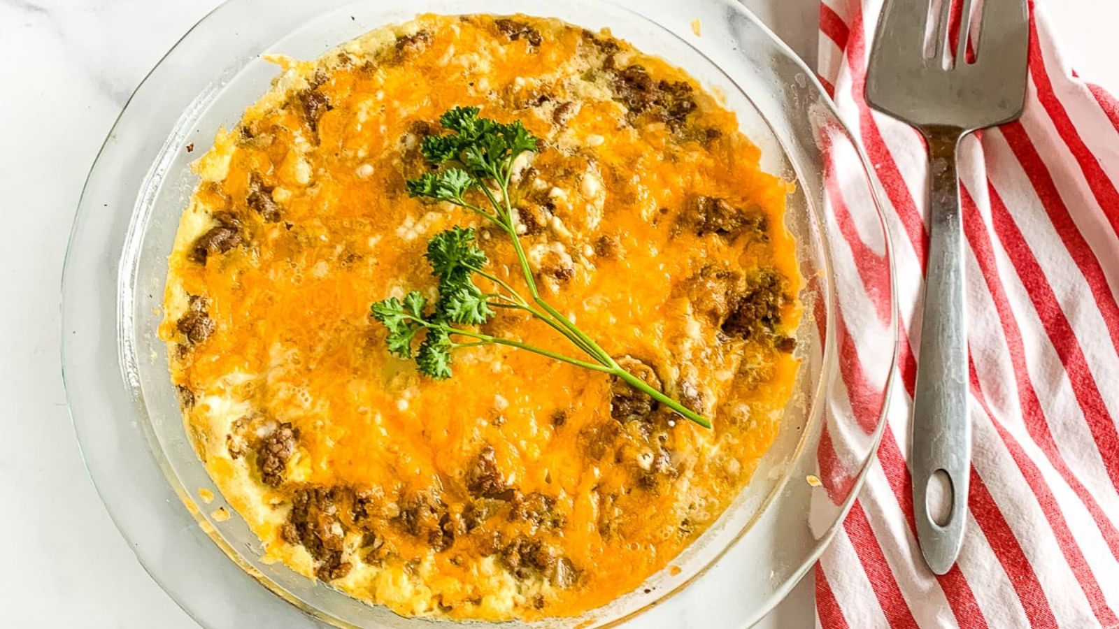 Bisquick cheeseburger pie on a glass tray.