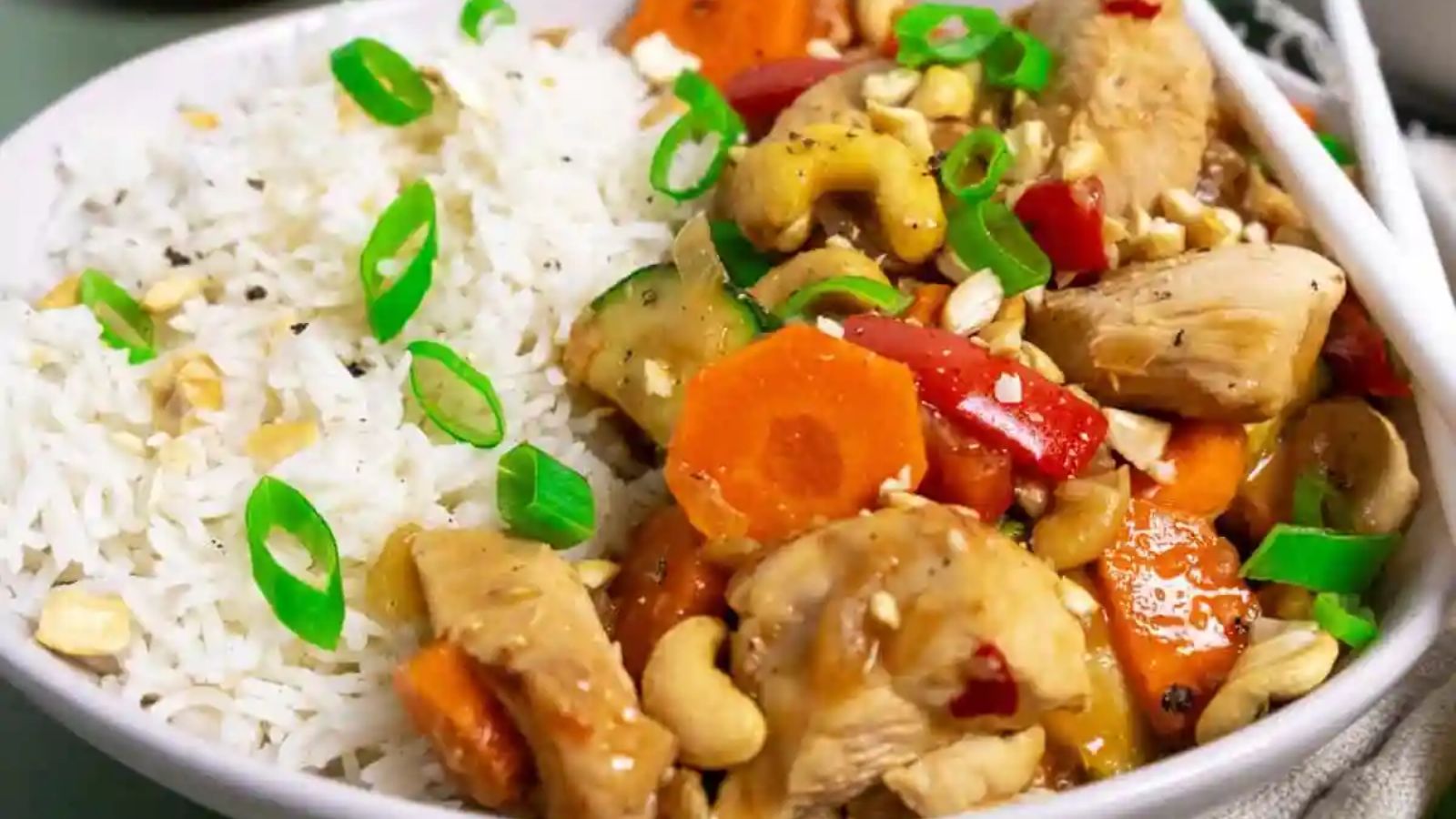 Chicken and vegetables with rice on a plate.