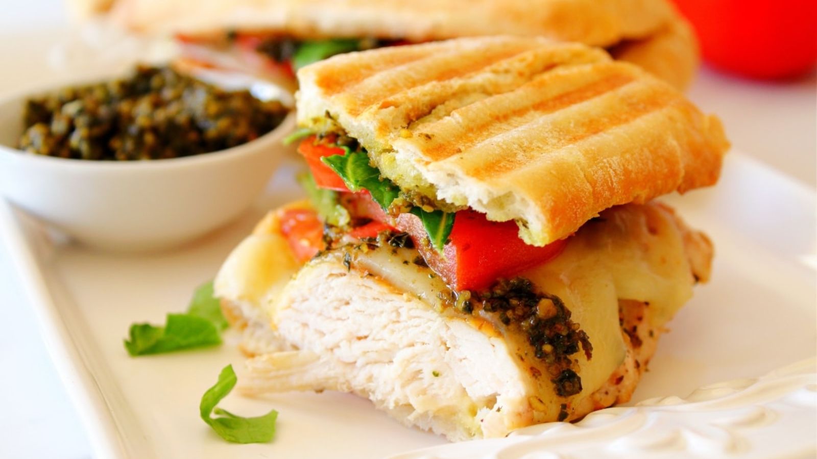 Chicken  pesto panini on a plate.