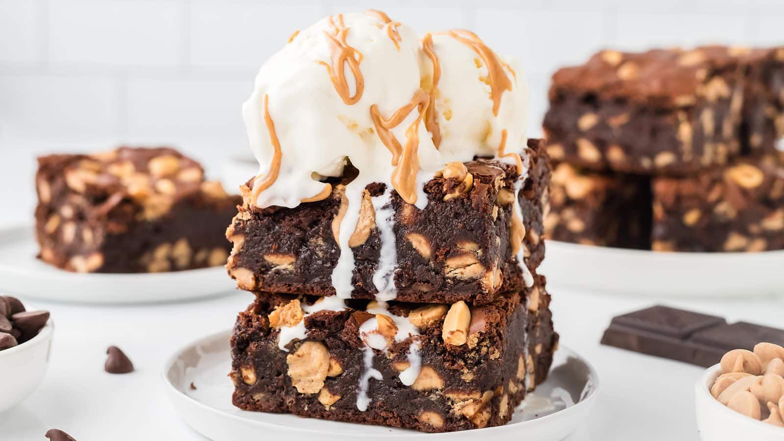 Peanut butter brownies with a scoop of ice cream on top.
