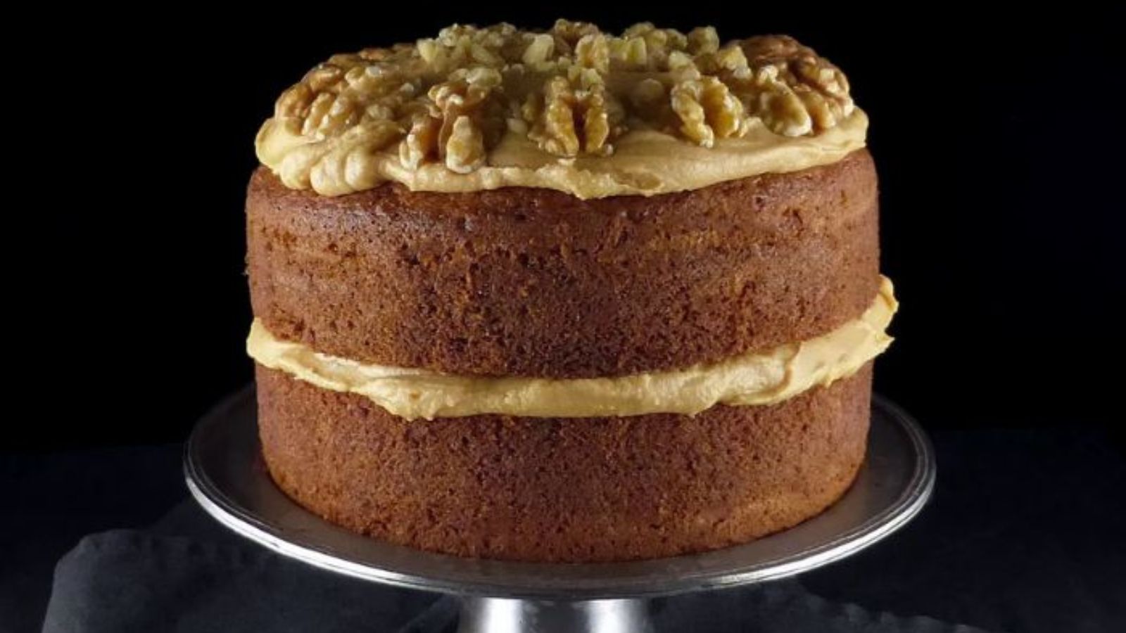 Coffee and walnut cake on a white background.
