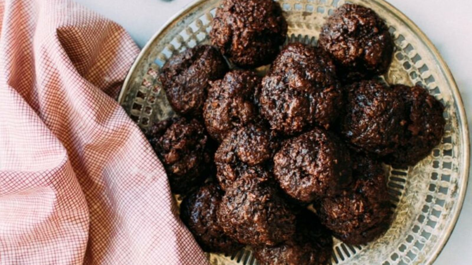 Chocolate cookies with coconut on a plate.