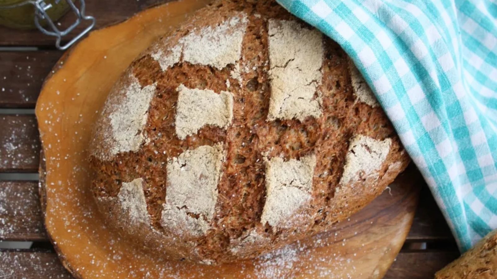 A whole beer bread on a wooden board.