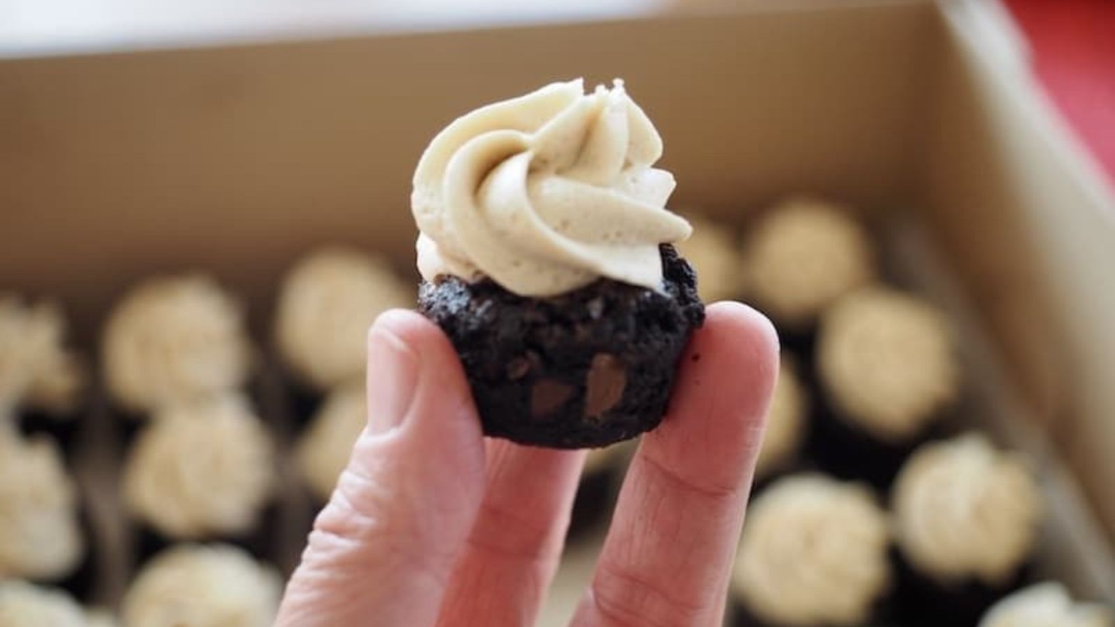 Brownie bites with buttercream on top.
