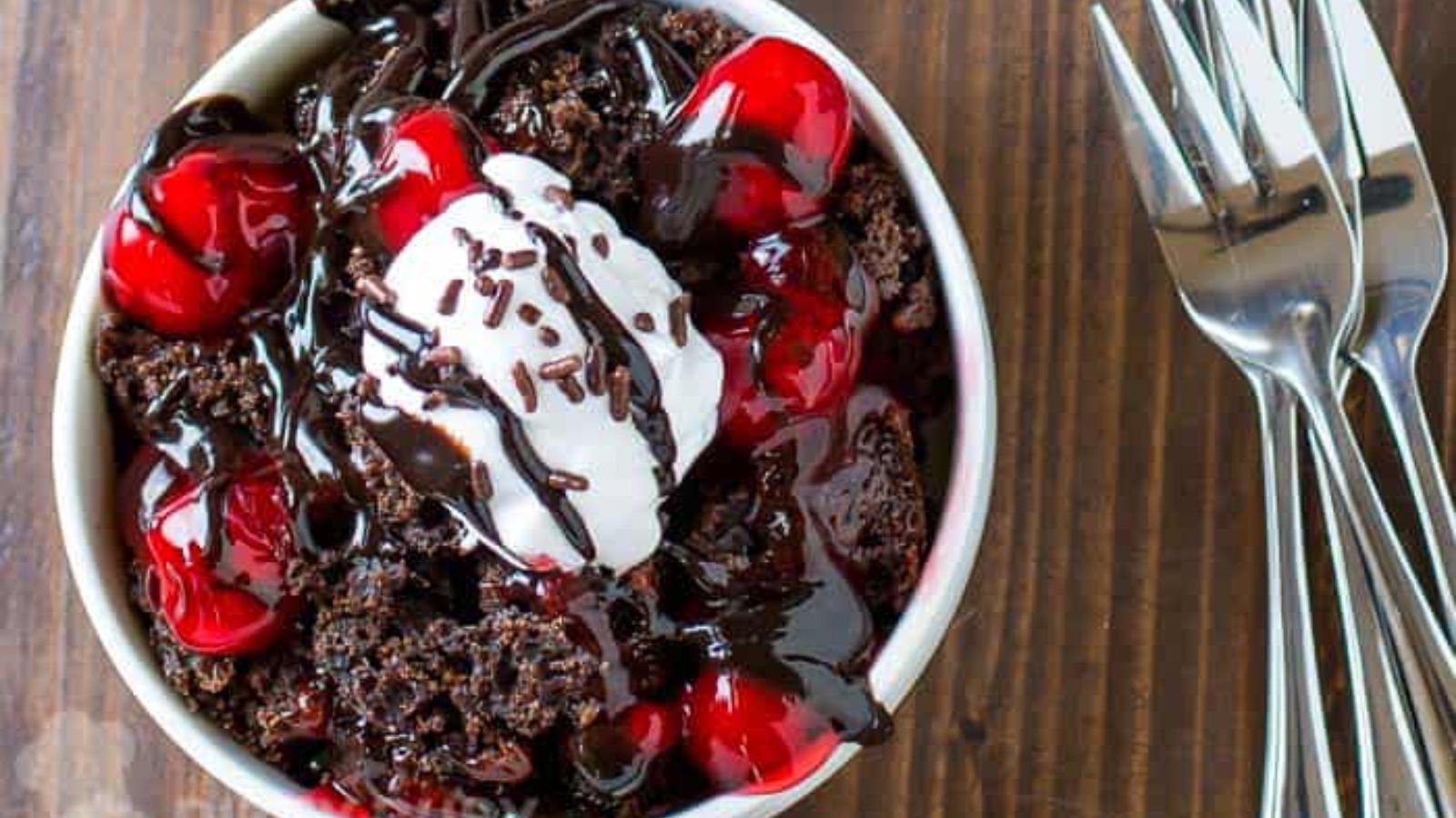 Chocolate cake with cherries on top.