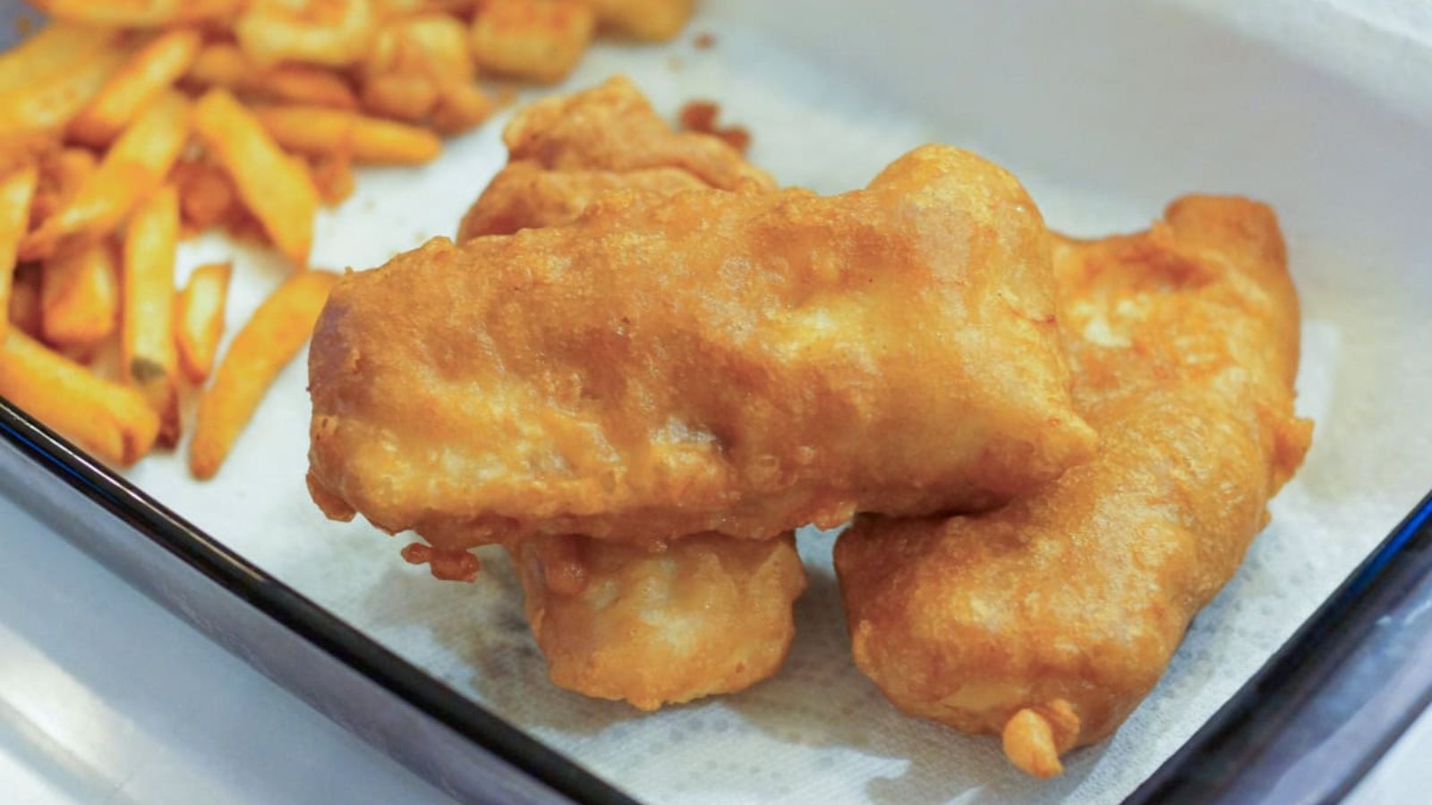 Battered cod on a plate.