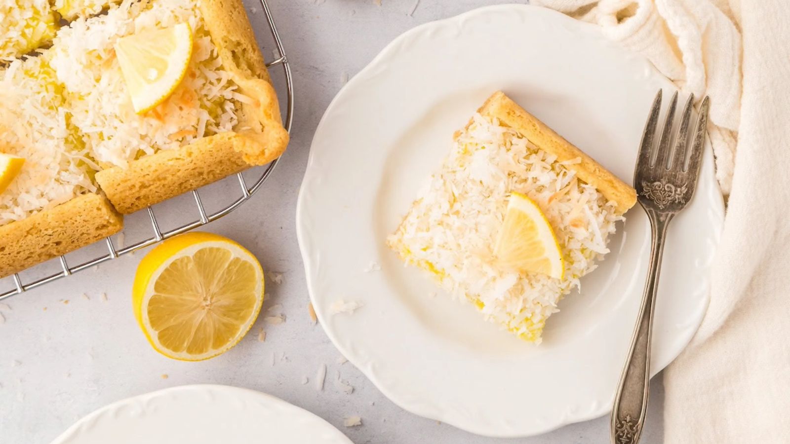 Lemon coconut bars on a plate.