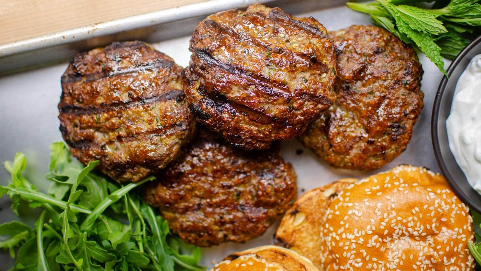 Lamb burgers on a tray.