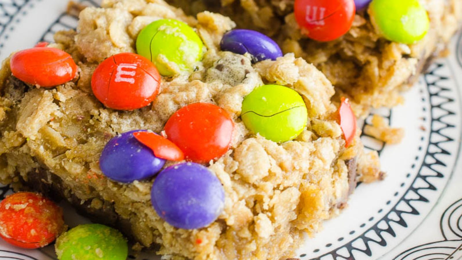 Cookie bars with m&m's on a plate.